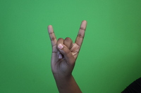 Irish H- Thumb covering middle and ring finger, pinky and index fingers pointed